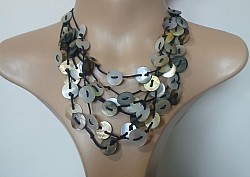 Multi-strand shell beads on black cord and button up back necklace $44